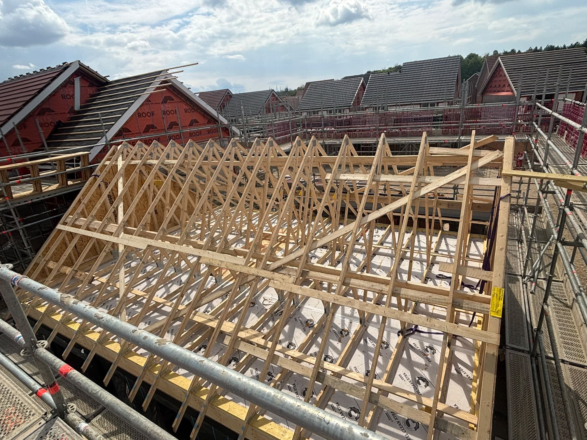 Installed timber roof trusses viewed from scaffolding